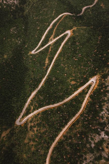 A breathtaking aerial view of winding mountain road in Seydişehir, surrounded by lush forest.