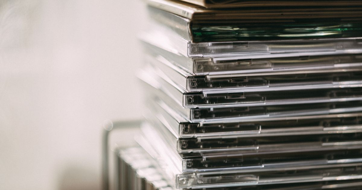 A stack of transparent CD cases neatly aligned, creating a still life composition.