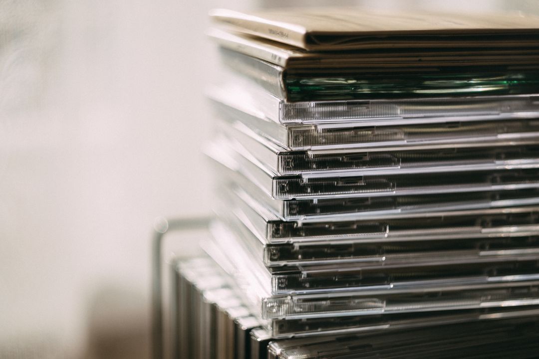 A stack of transparent CD cases neatly aligned, creating a still life composition.