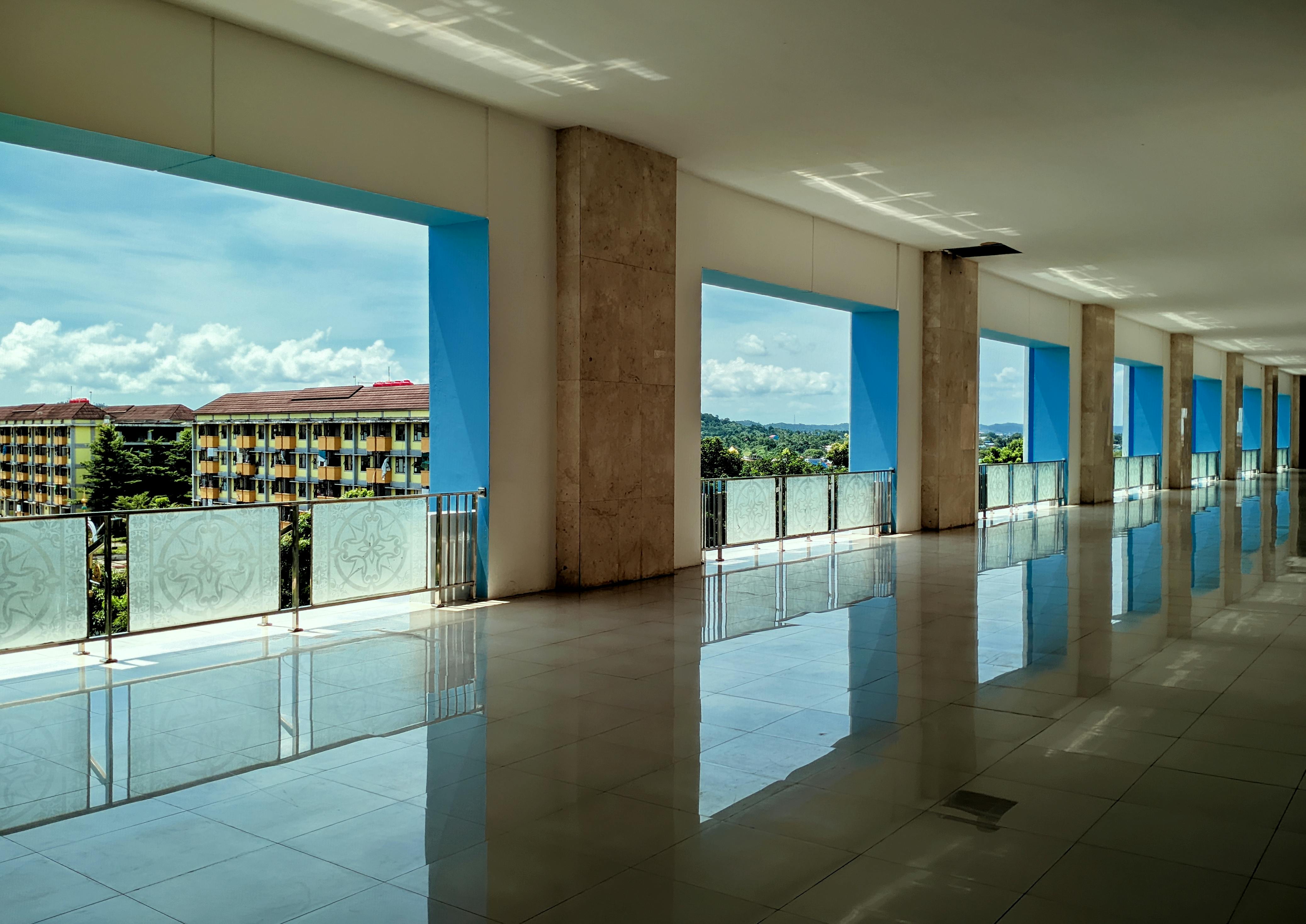 Explore an elegant corridor with a stunning outdoor view in Riau Islands, Indonesia.