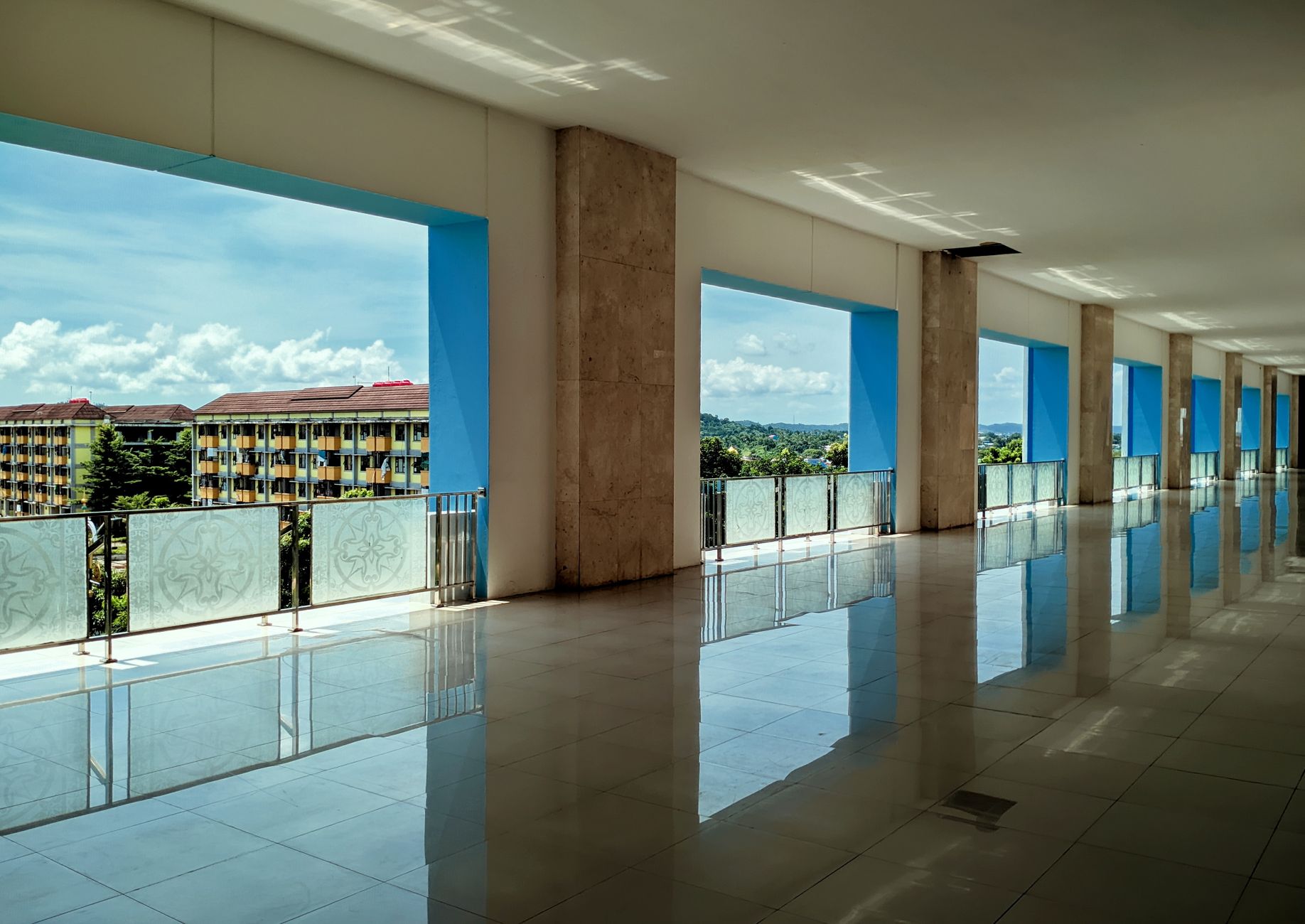 Explore an elegant corridor with a stunning outdoor view in Riau Islands, Indonesia.