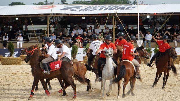 Action-packed scene of a horseback game at a cultural festival in Istanbul, Turkey.