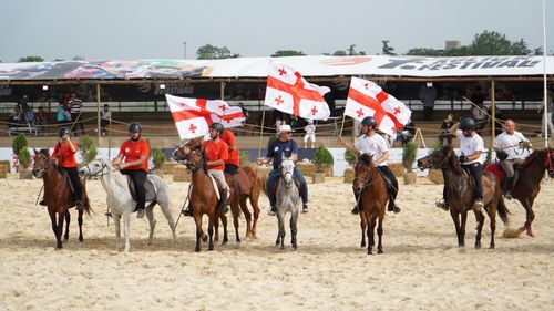 Free Riders with Georgian flags at an equestrian event in İstanbul, Türkiye. Stock Photo