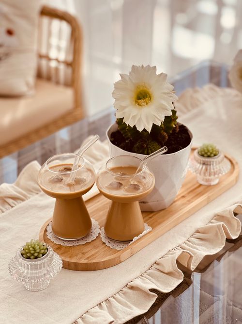 Free Chic setup with iced coffee glasses and cactus on a wooden tray, perfect for lifestyle scenes. Stock Photo