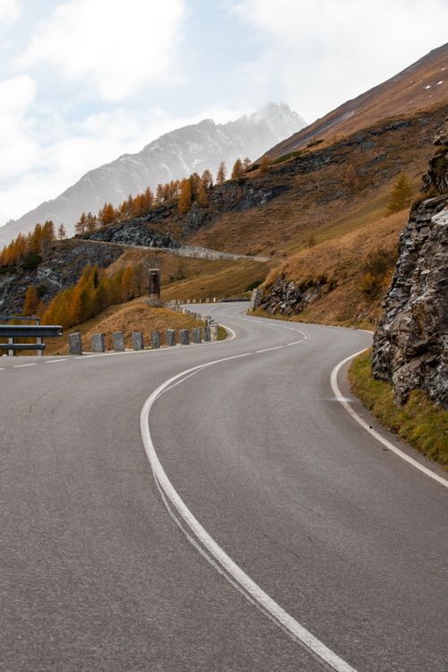 Winding mountain road through lush green Austrian Alps