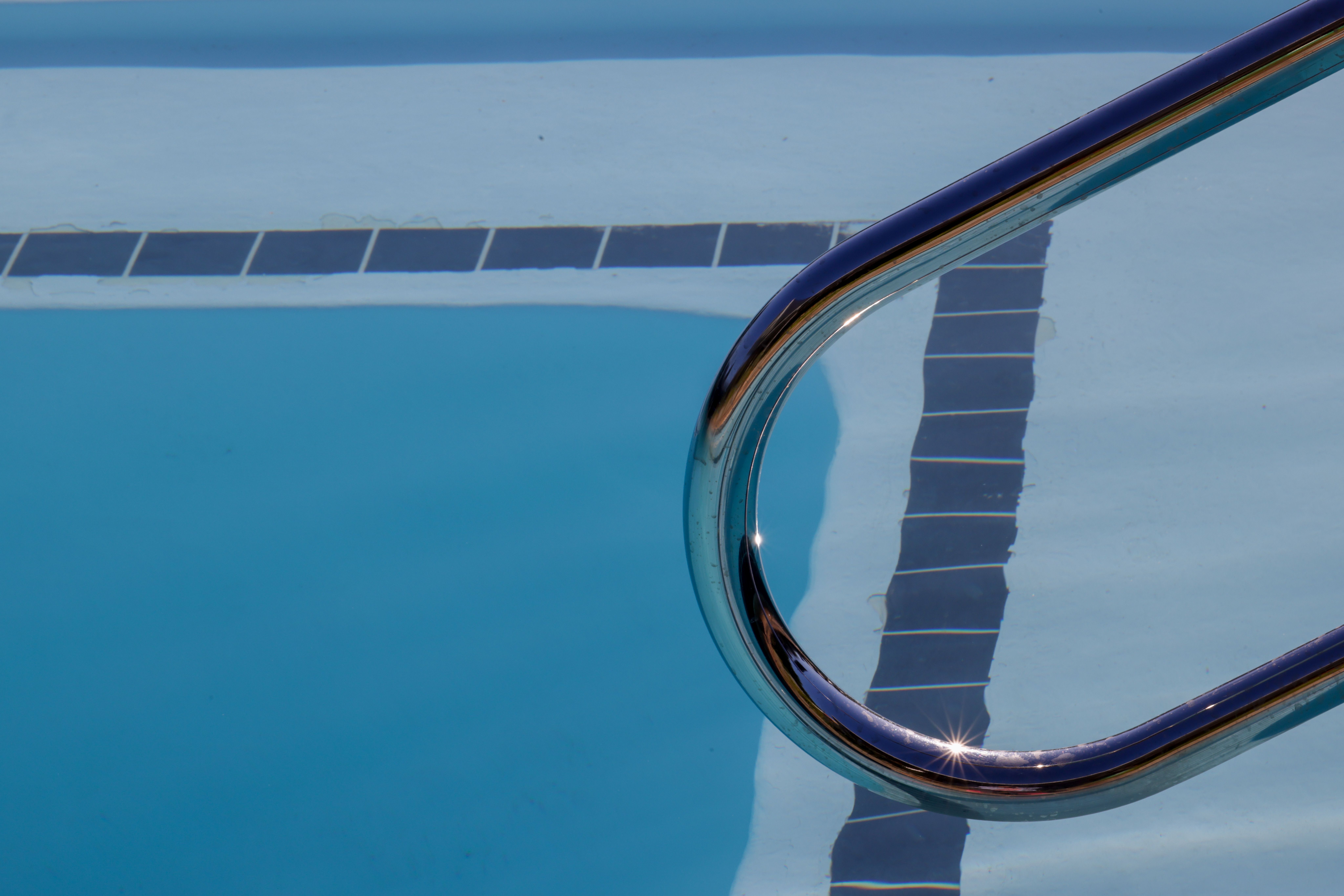 Close-Up of Pool Water and Ladder Reflection · Free Stock Photo