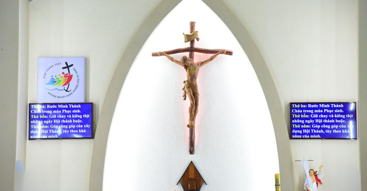 Modern church interior with large LED screens displaying lyrics and visuals during worship