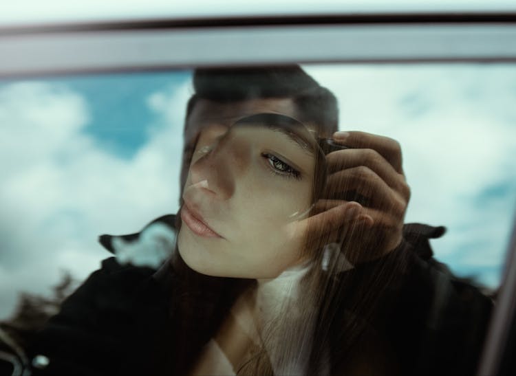 Thoughtful Woman Looking Through Car Window