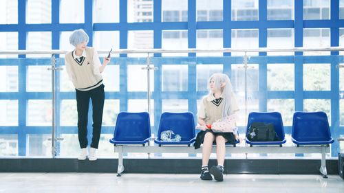 Free Two cosplayers with blue hair and elf ears in a bright urban corridor. Stock Photo