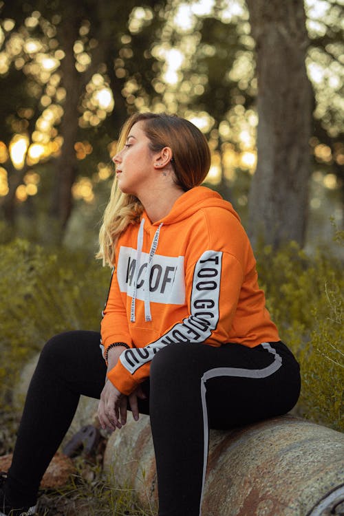 Photo Of Woman Wearing Orange Hoodie