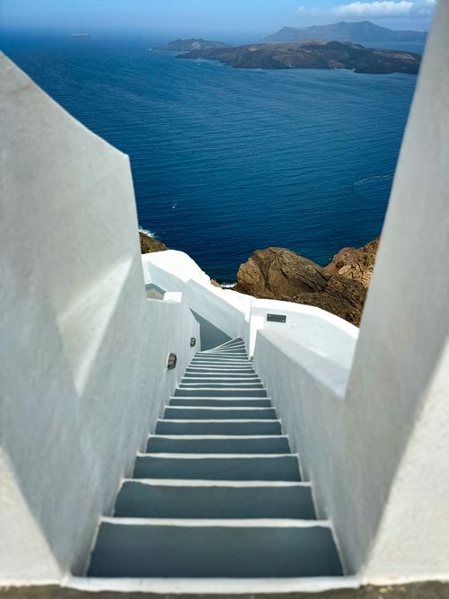 Free Scenic view of white stairs descending towards the Aegean Sea on Santorini, Greece. Stock Photo