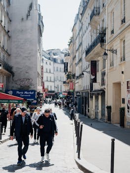 Explore a bustling street in Paris capturing the city's vibrant atmosphere and classic architecture.
