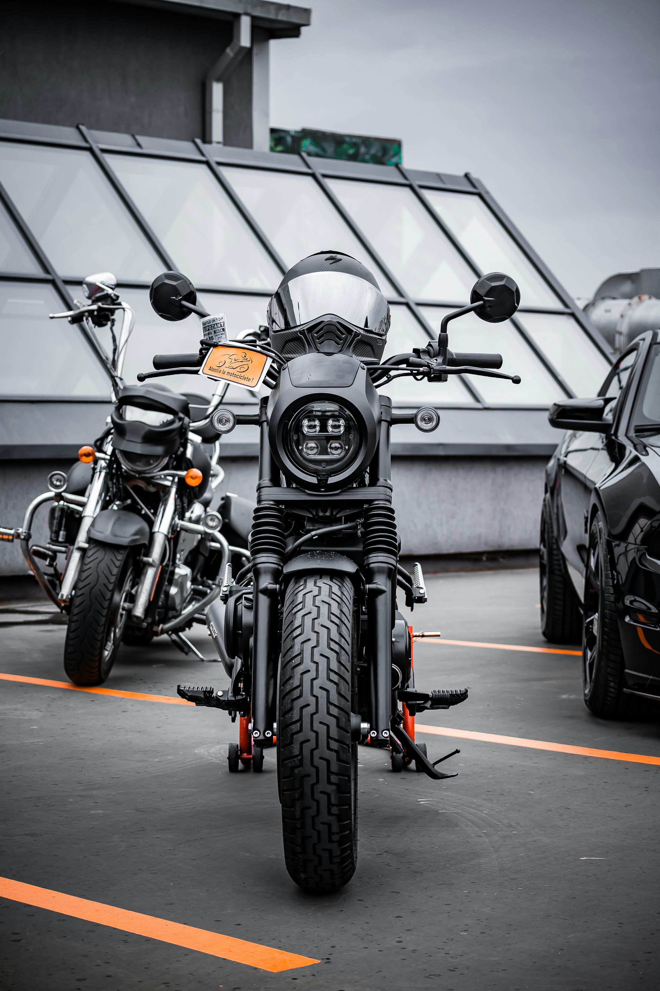 A modern motorcycle parked on an urban rooftop lot, showcasing its sleek design and style.