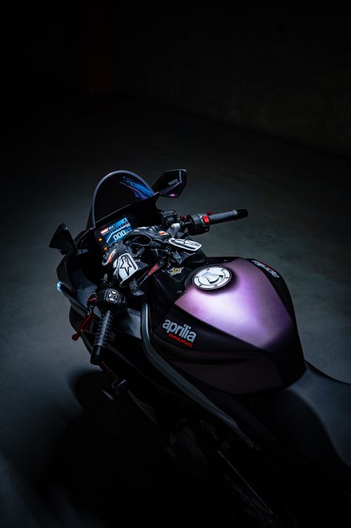 Free Dark and moody shot of an Aprilia motorcycle with dramatic lighting in a garage. Stock Photo