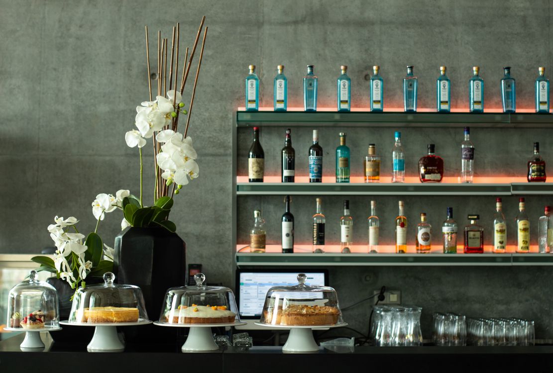 Stylish Bar Interior with Drinks and Desserts · Free Stock Photo