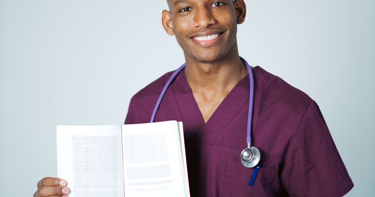A medical professional with a stethoscope holding a book.