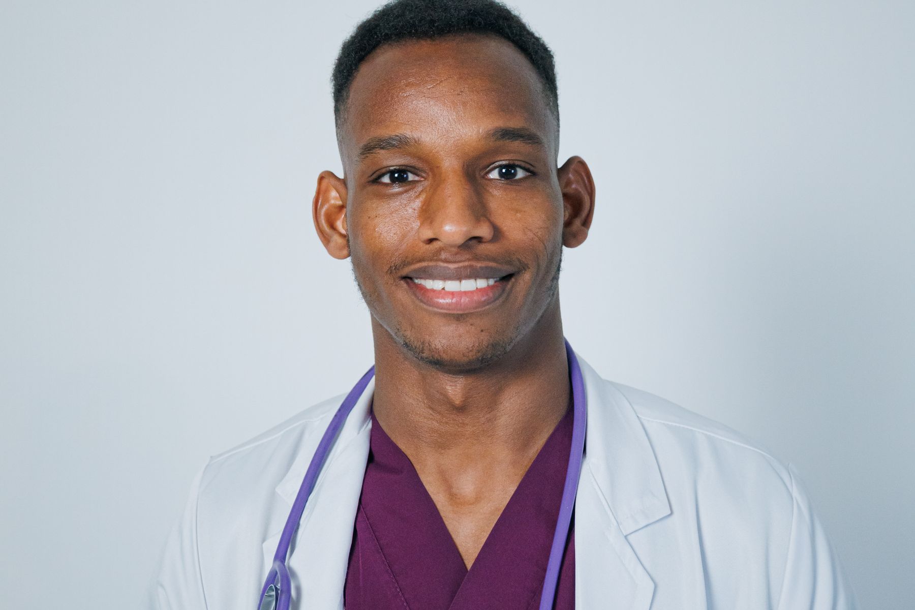 Smiling physician portrait in a modern clinical setting