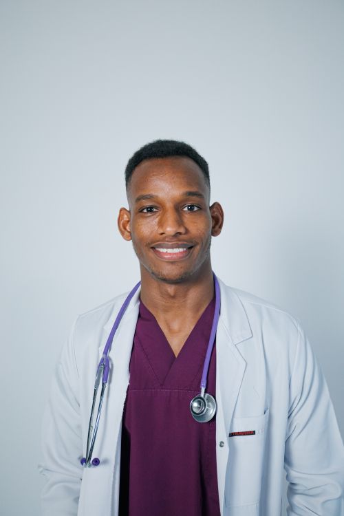 Free Smiling doctor in lab coat with stethoscope, symbolizing healthcare and professionalism. Stock Photo