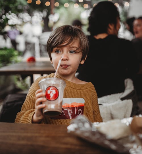 Child Drinking a Chocolate Beverage
