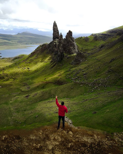 A Man Wearing Red Jacket Doing Peace Sign