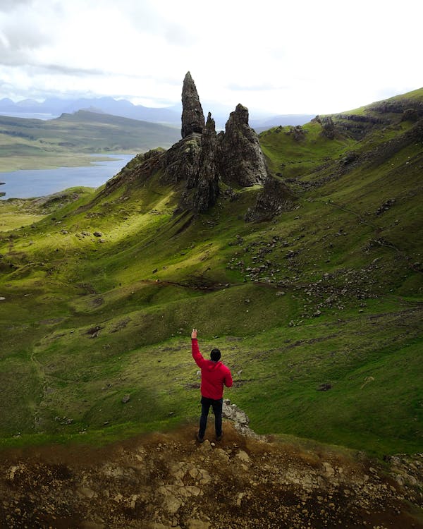 A Man Wearing Red Jacket Doing Peace Sign