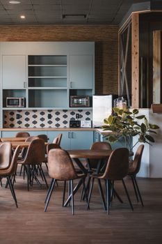 Modern cafe interior featuring wooden tables and chairs with stylish design.