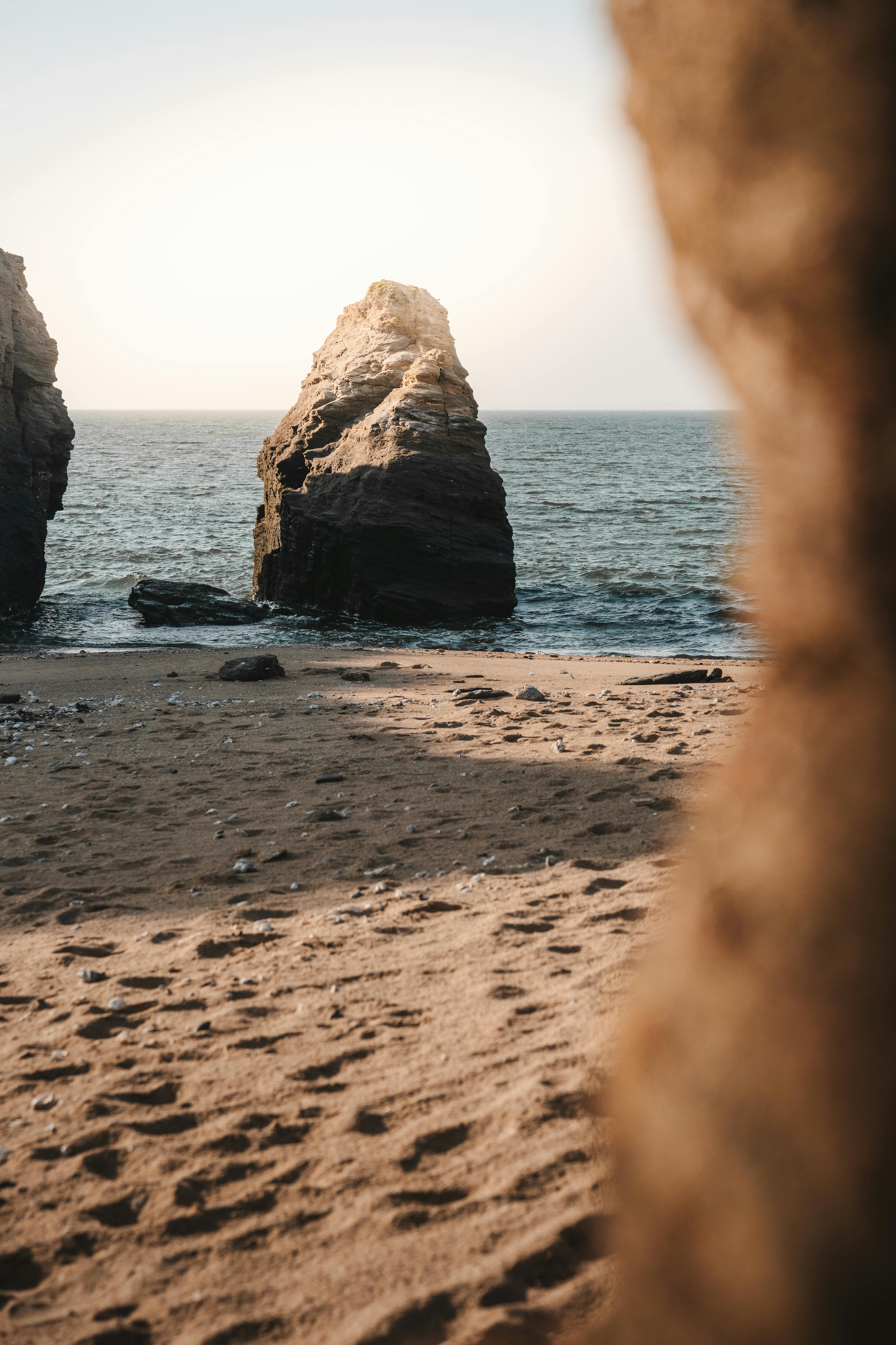 Captivating rock formations on a tranquil beach, perfect for travel inspiration.