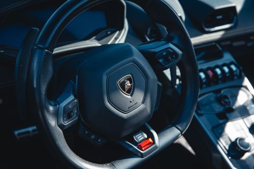 Free Close-up of luxury car steering wheel and dashboard controls. Stock Photo