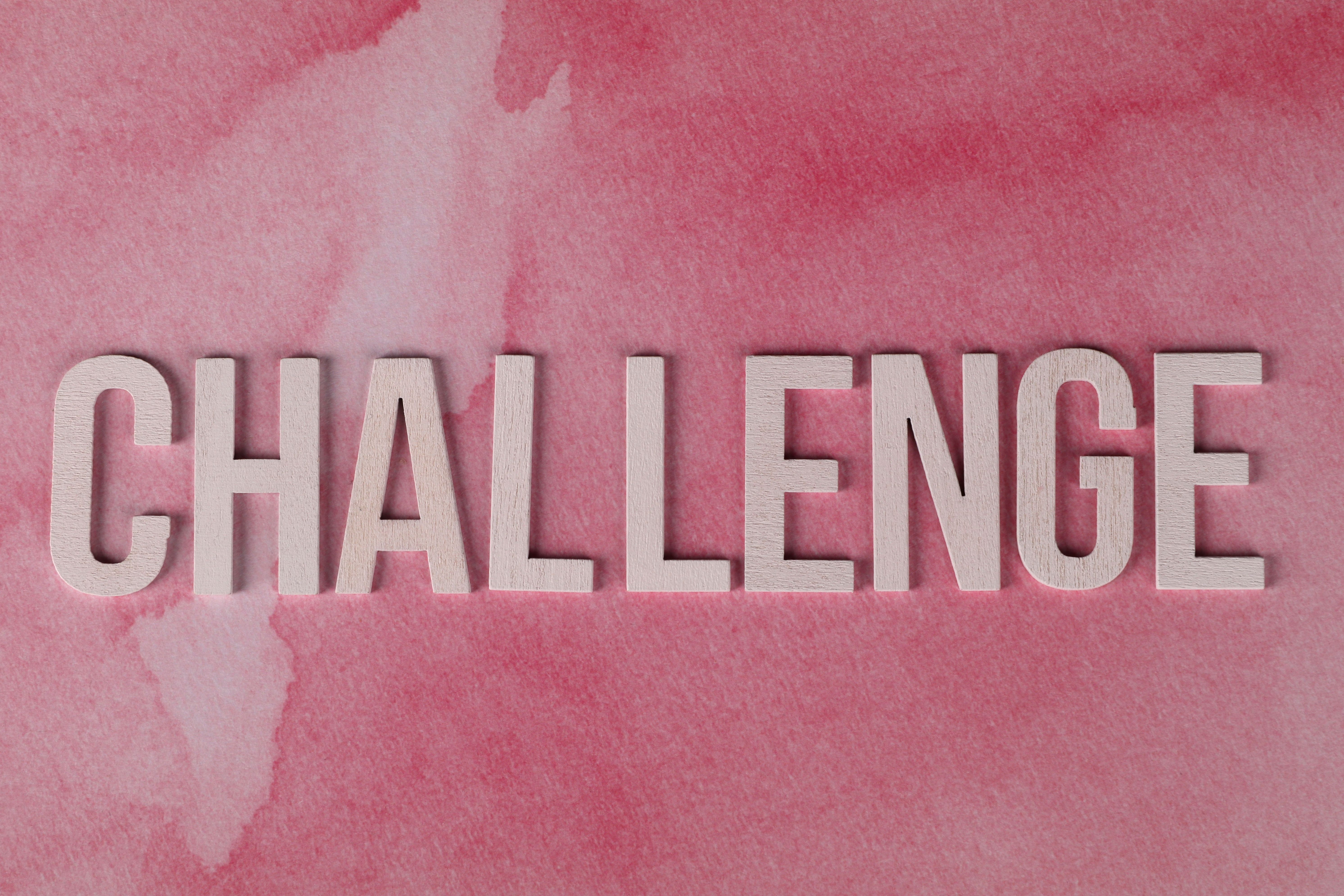 Text 'CHALLENGE' in bold on textured pink watercolor background for motivation. — photo by Ann H