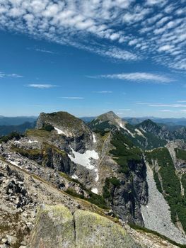 Breathtaking panoramic view of the rugged Andean mountain range with prominent rocky peaks and clear skies.
