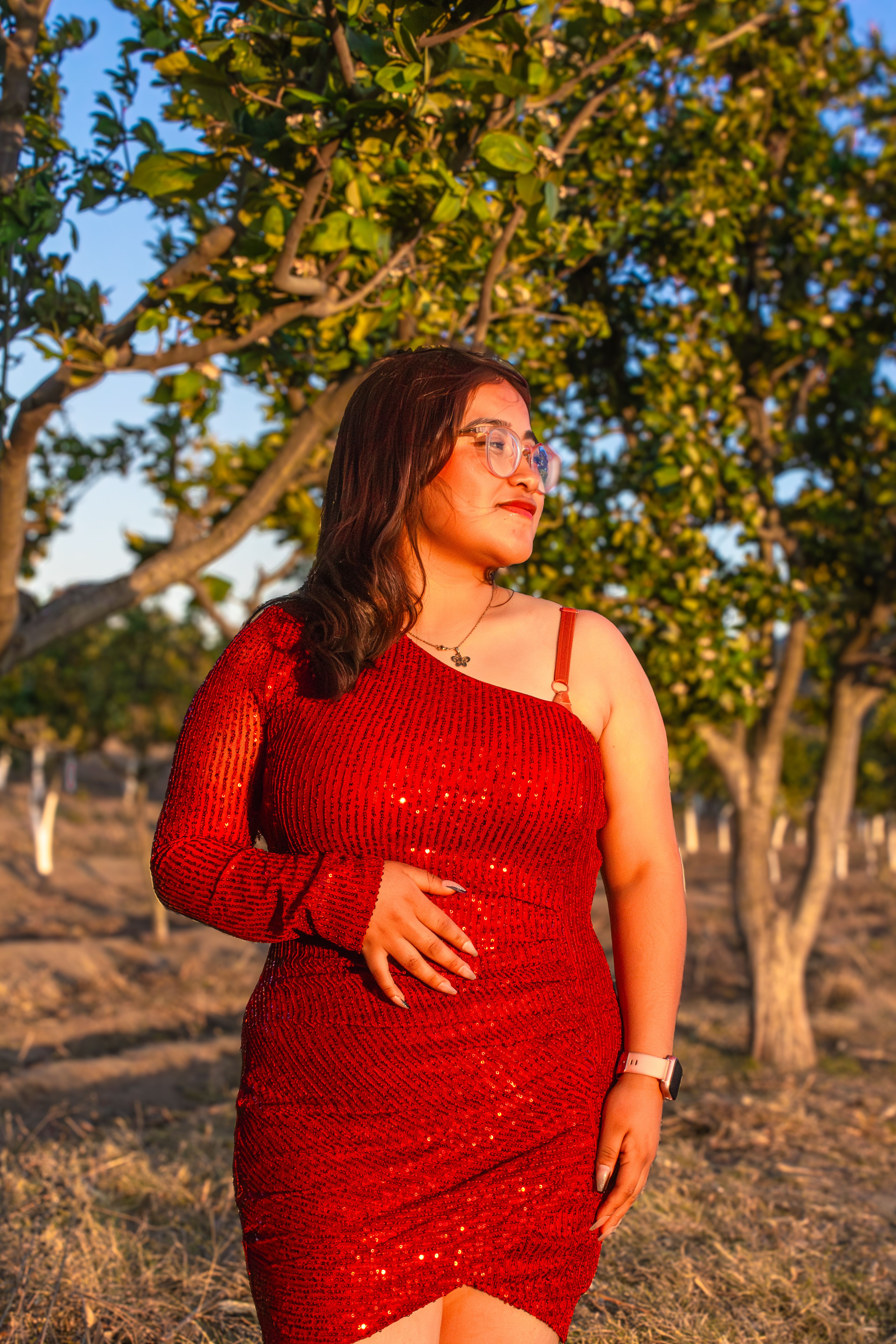 Woman in Red Dress in Sunny Orchard Setting · Free Stock Photo