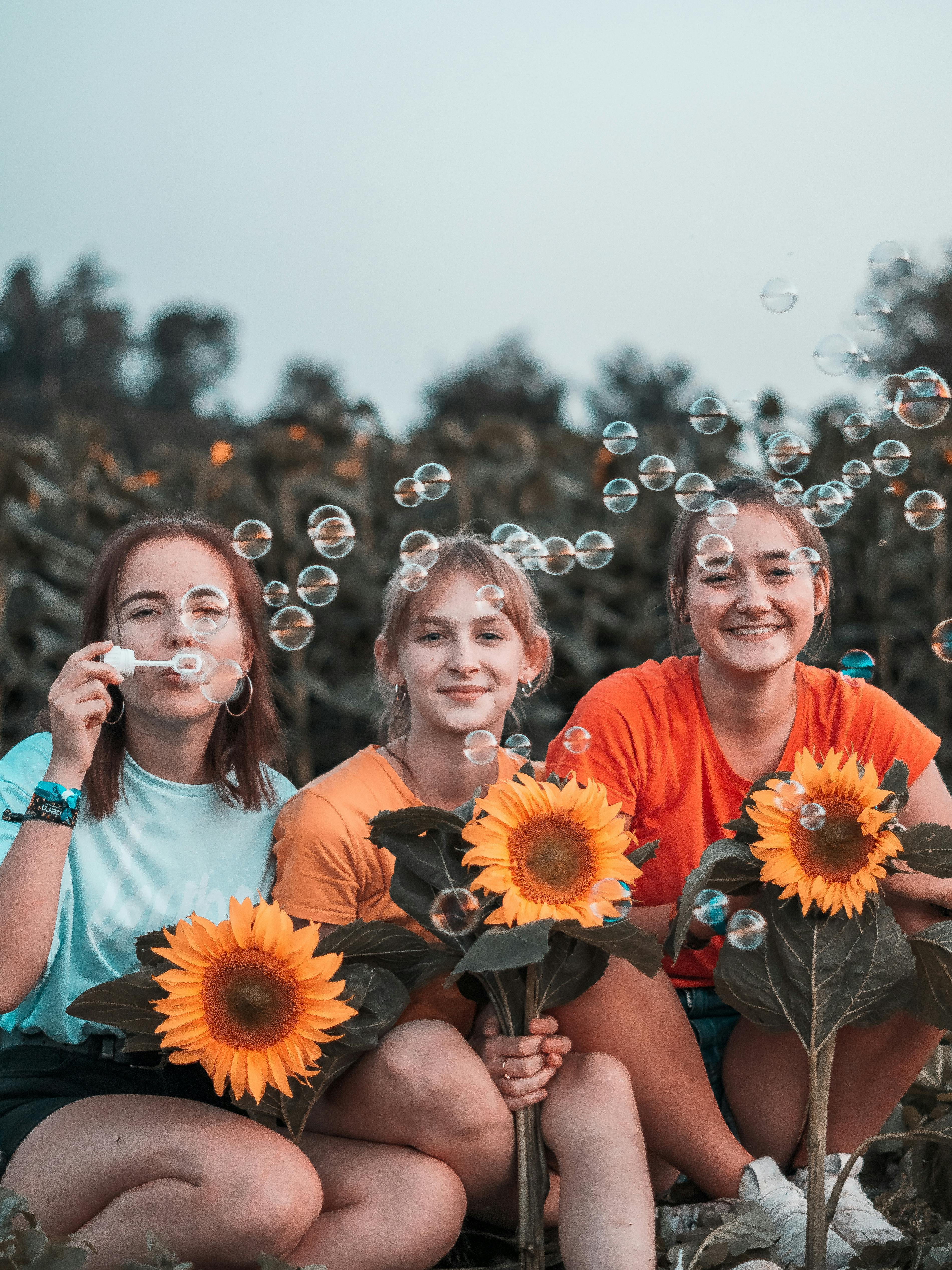 photo of women sitting beside each other