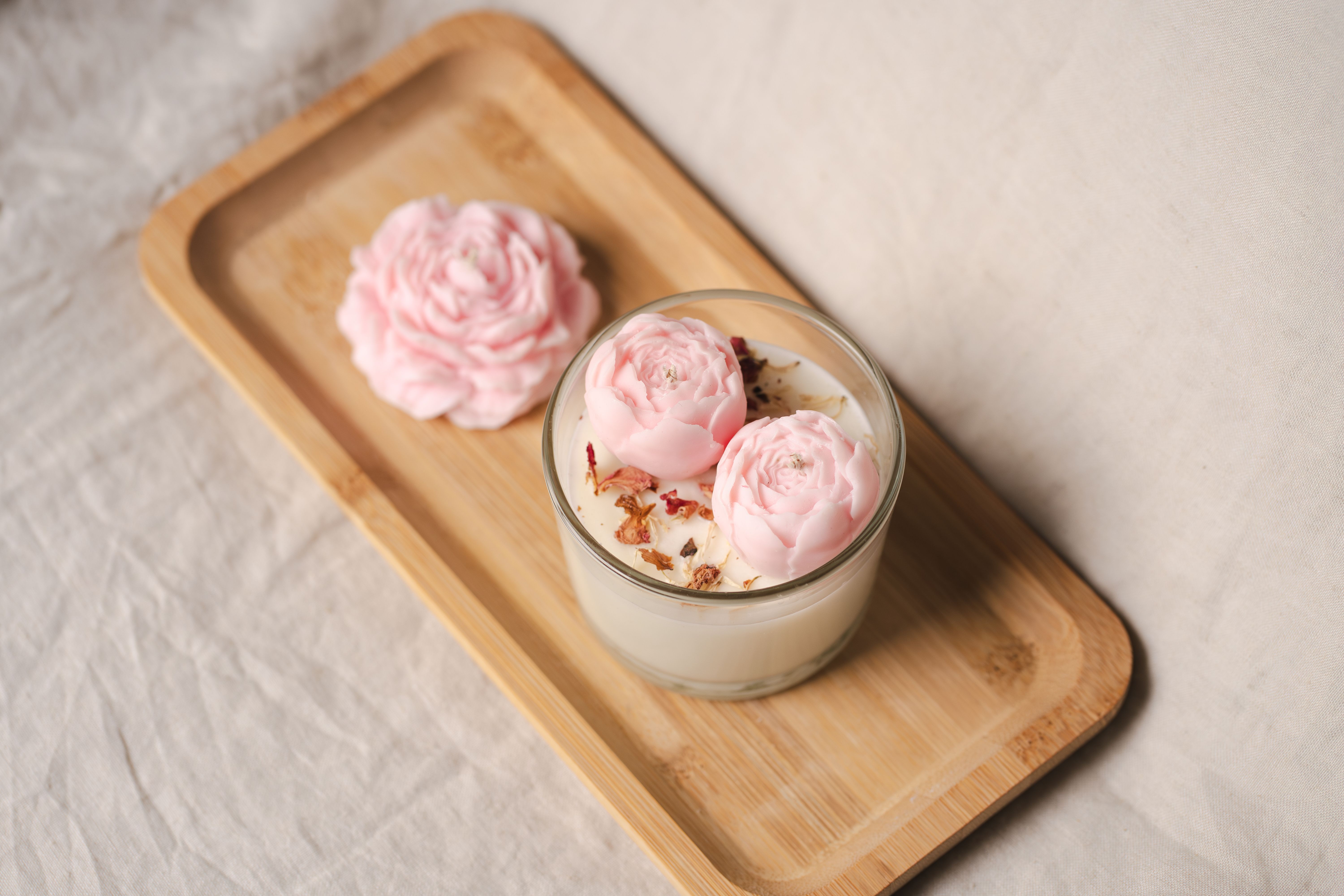 Aesthetic home decor featuring a floral candle display in a cozy setting.
