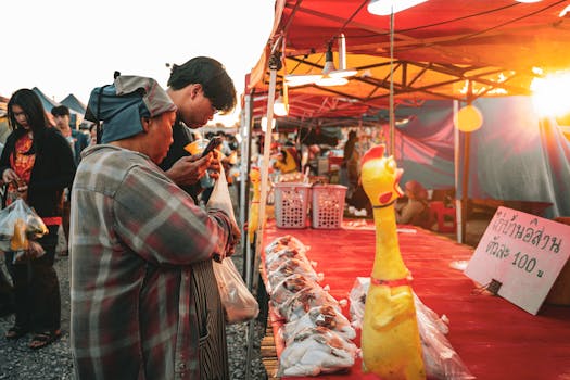 Vibrant scene of an Asian night market with people shopping at sunset.