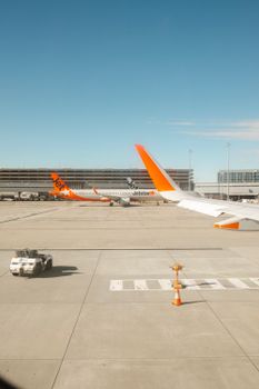 Jetstar airplanes lined up at Melbourne Airport Terminal 4, showcasing modern aviation.