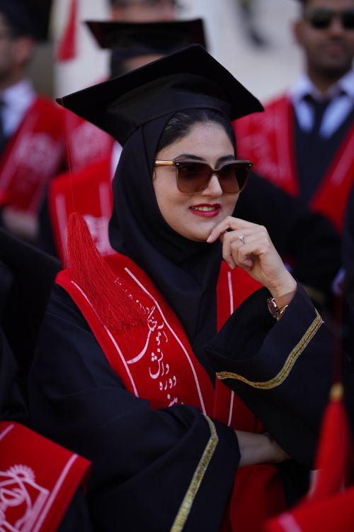 Free Confident graduate in ceremonial attire attending a university graduation ceremony in Iran. Stock Photo