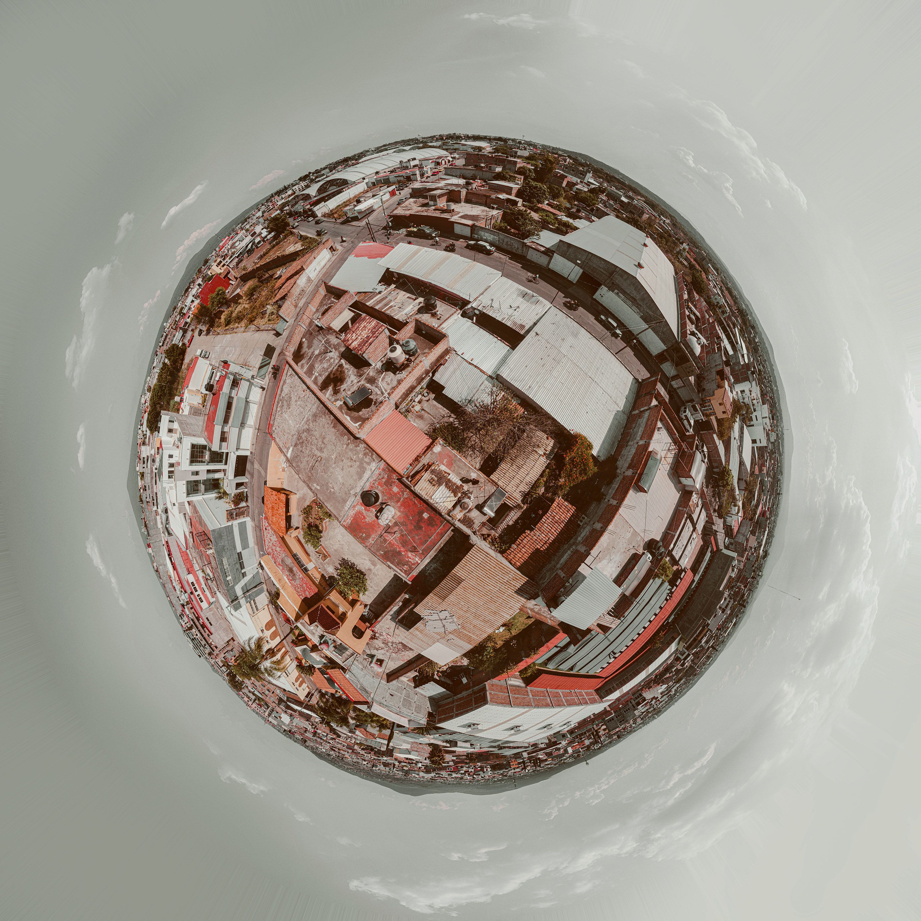 Aerial photograph of a cityscape in a spherical format, showcasing abstract urban design.