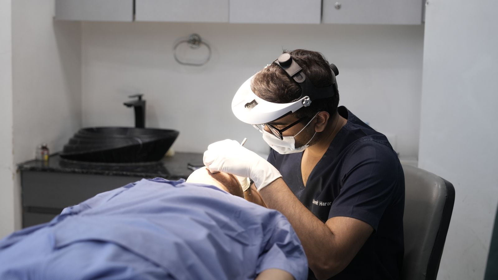 Indian doctor providing treatment to a patient in a Delhi clinic
