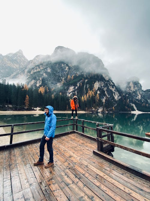 Free Photo of People Standing on a Lake Boardwalk Stock Photo