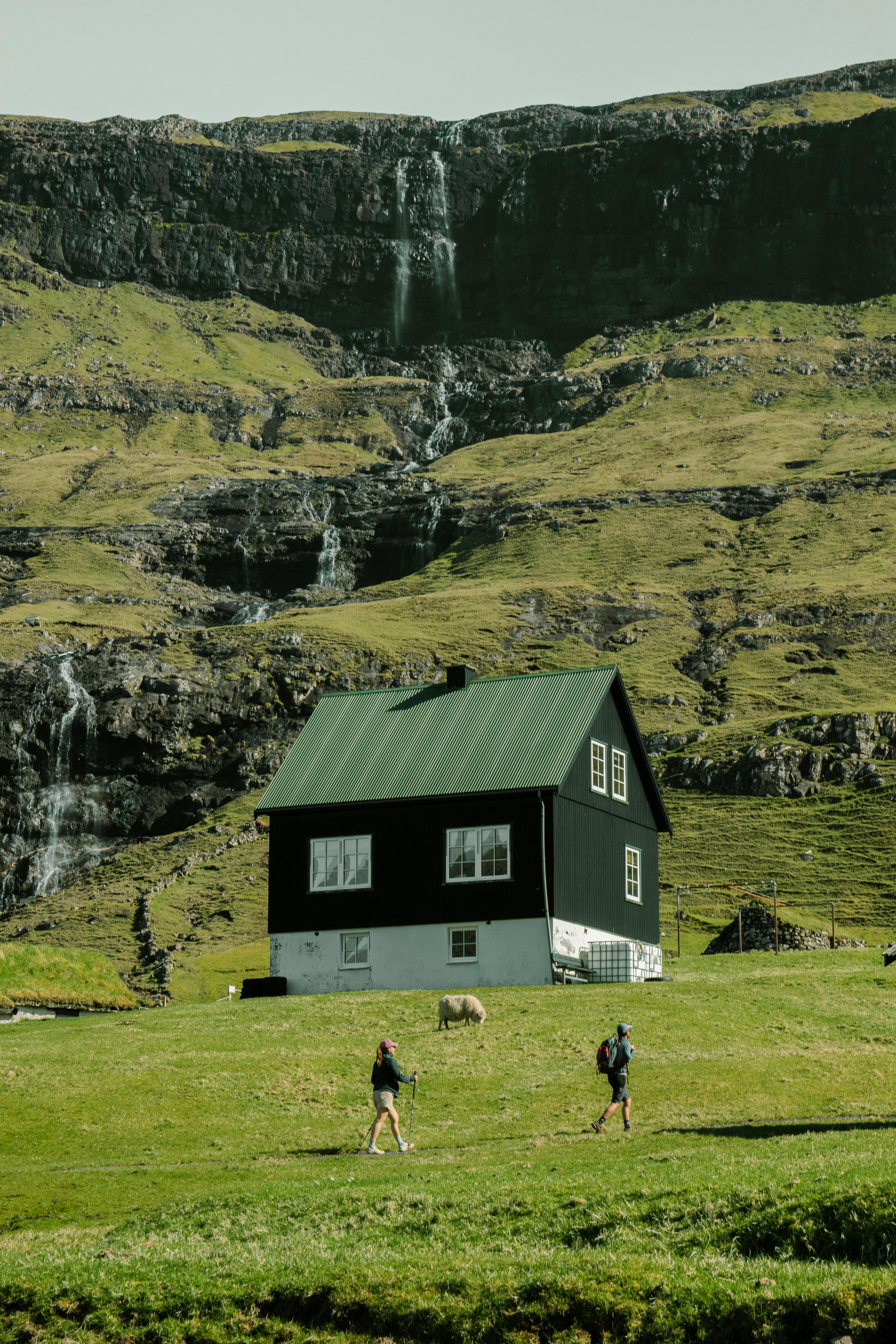 Explore the scenic beauty of the Faroe Islands with a lone house in a green valley.