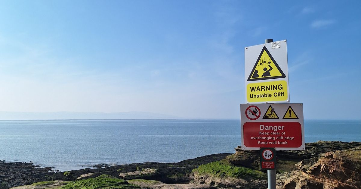 Overlooking Sign Warning Sign Overlooking Scenic Coastal Cliffs · Free Stock Photo