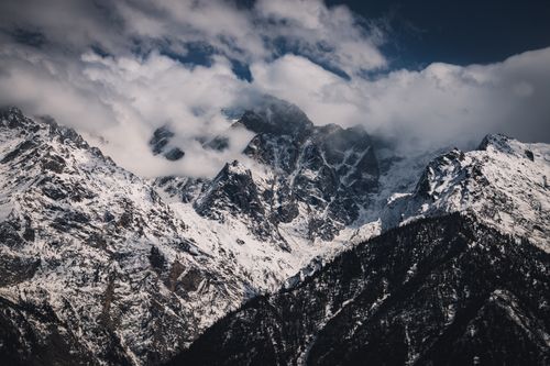Free Breathtaking view of the snow-capped Himalayan peaks with clouds enveloping the mountains. Stock Photo