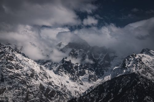 Free Snow-covered Himalayan peaks shrouded in dramatic clouds for an awe-inspiring view. Stock Photo