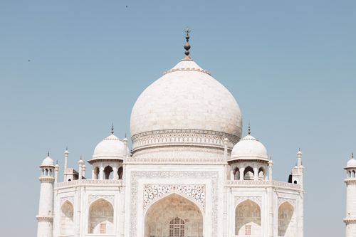 Free Close-up view of the iconic Taj Mahal dome with clear blue sky backdrop. Stock Photo