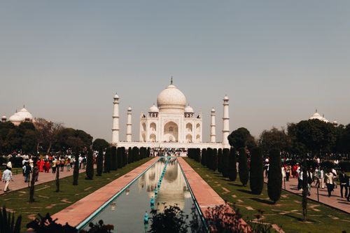Free A beautiful view of the Taj Mahal with tourists and reflection in Agra, India. Stock Photo