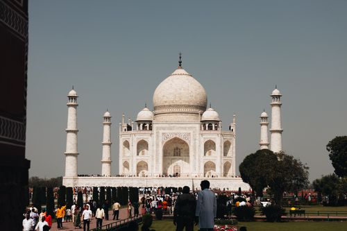 Free Stunning view of the Taj Mahal with visitors exploring the iconic monument on a sunny day in Agra, India. Stock Photo