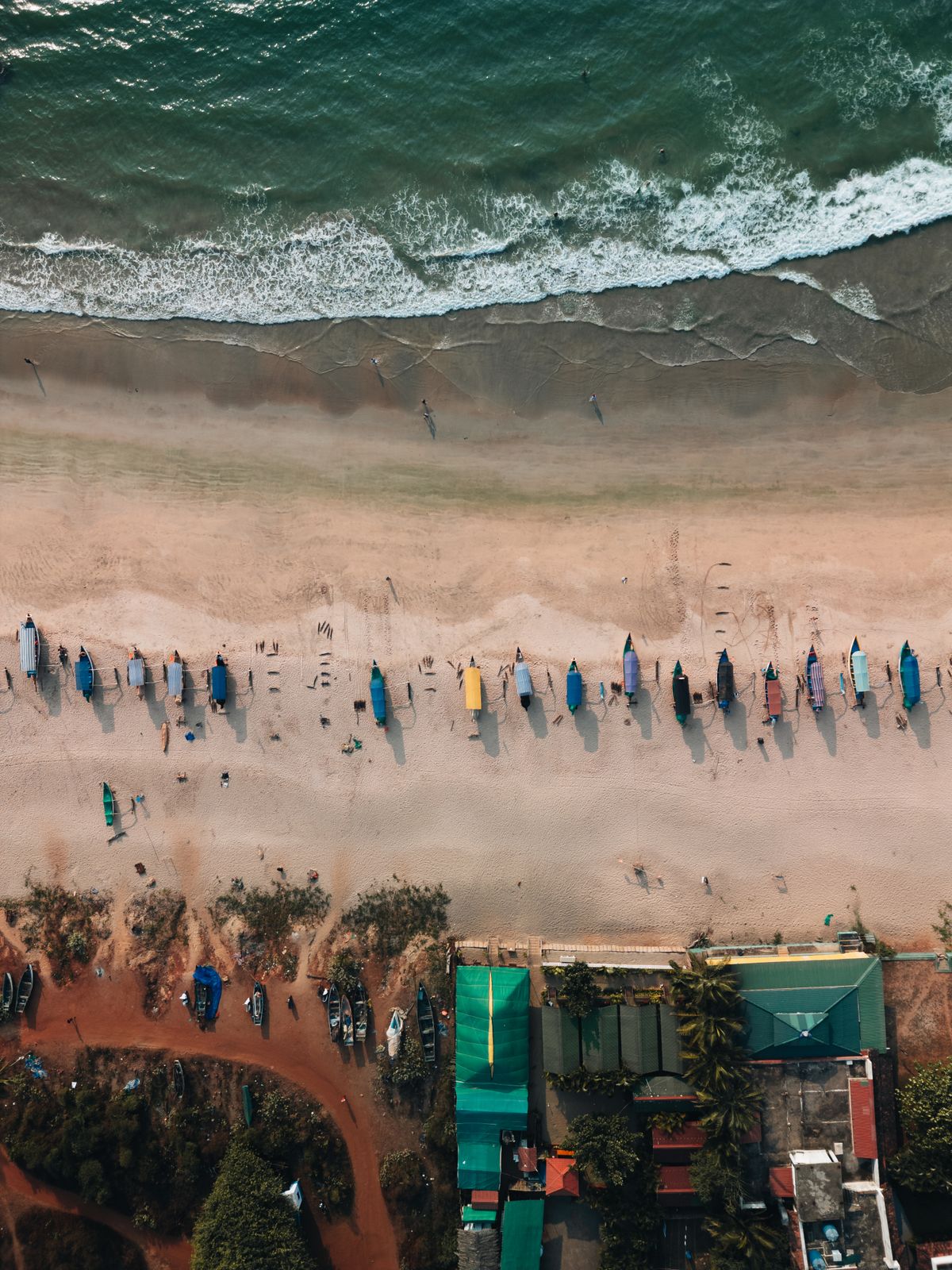 Aerial View of Colorful Boats on a Sandy Beach · Free Stock Photo