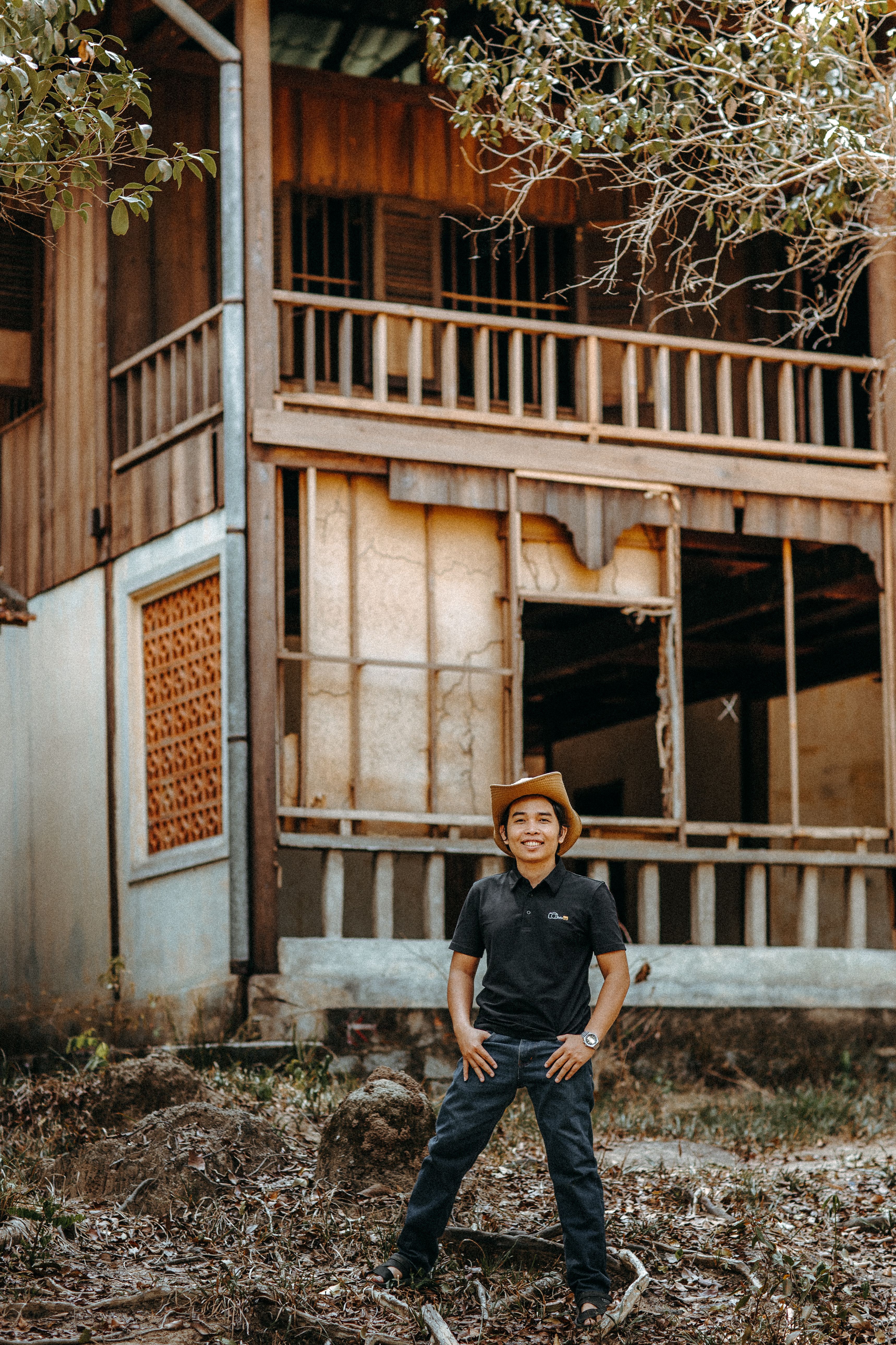 Portrait of a Man in Front of Rustic Wooden House · Free Stock Photo