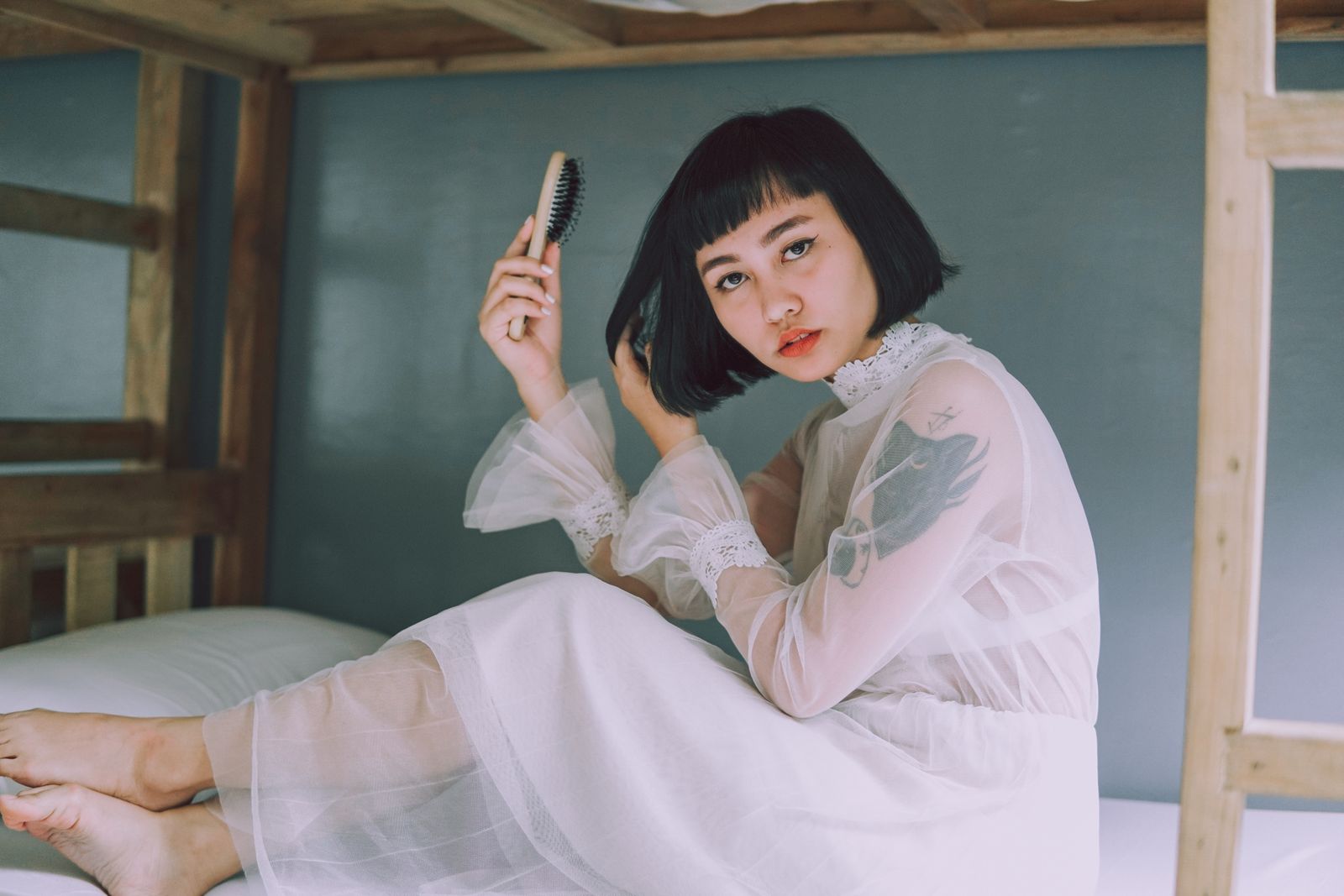 Person holding a hairbrush in a relaxed indoor setting
