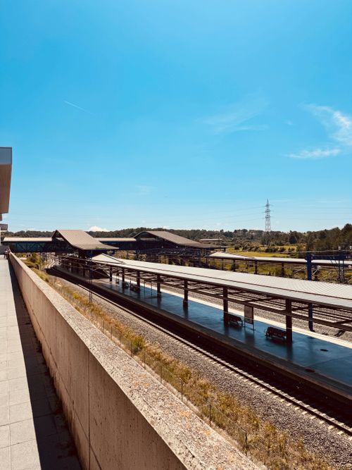 Free An empty railway station with clear blue skies and modern architecture. Stock Photo